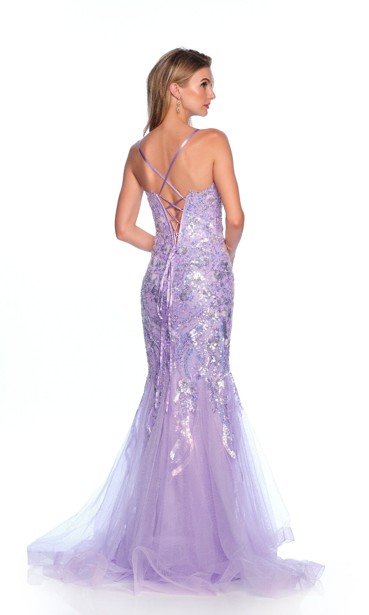 A woman wearing the Dave & Johnny 12143 long prom dress with lavender sequins and a lace-up back stands facing away from the camera against a white background.
